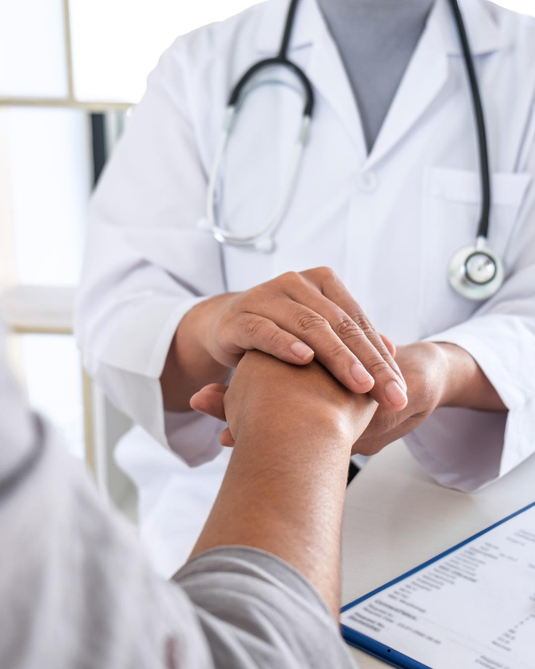 Provider holding a patient's hand during care
